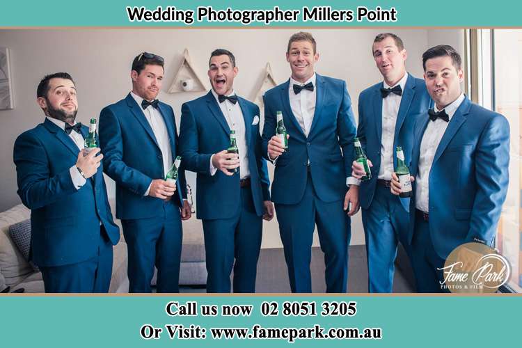 Groom and his secondary sponsors holding a bottle of beer Millers Point NSW 2000